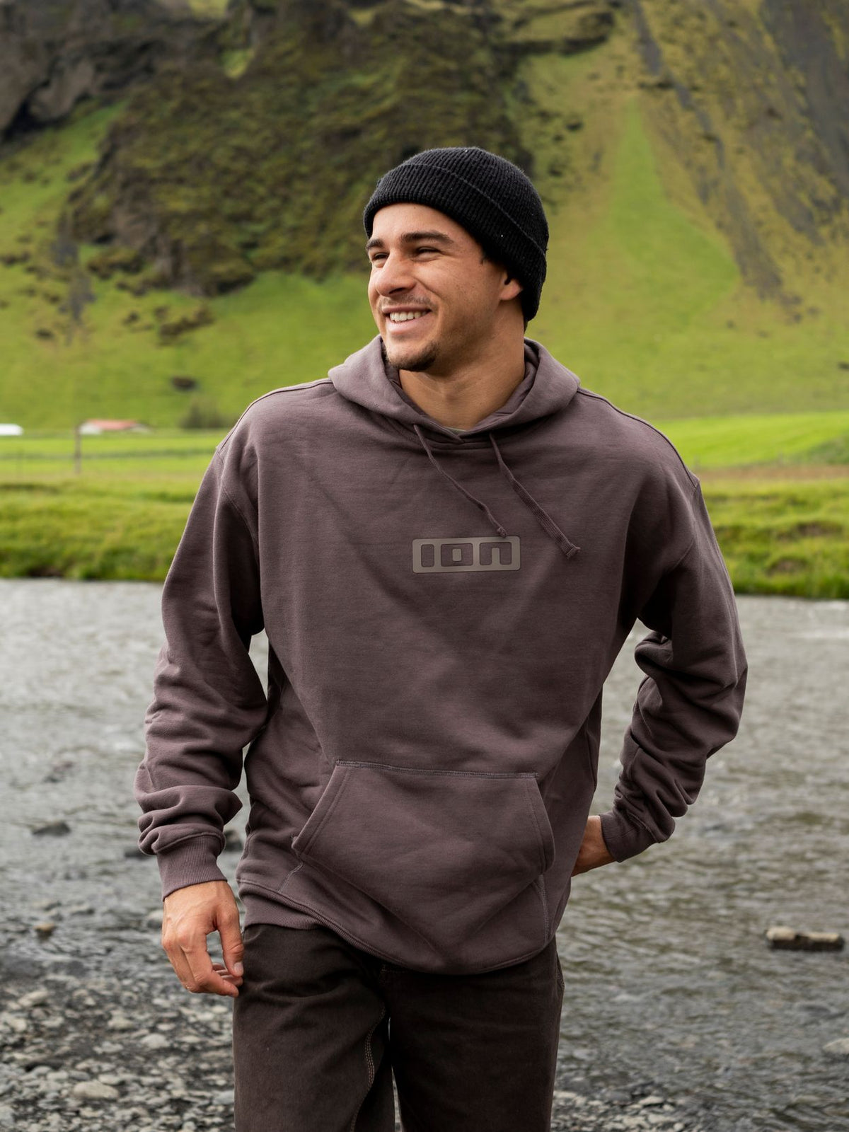ION IONIC Hoodie 2026 in Graubraun, Frontansicht auf Person getragen, mit Kapuze und ION-Logo