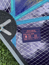 Duotone Duke SLS 5.8 2026 Kiteboard mit blauem und schwarzem Design, Draufsicht auf Board und Spezifikationsschild