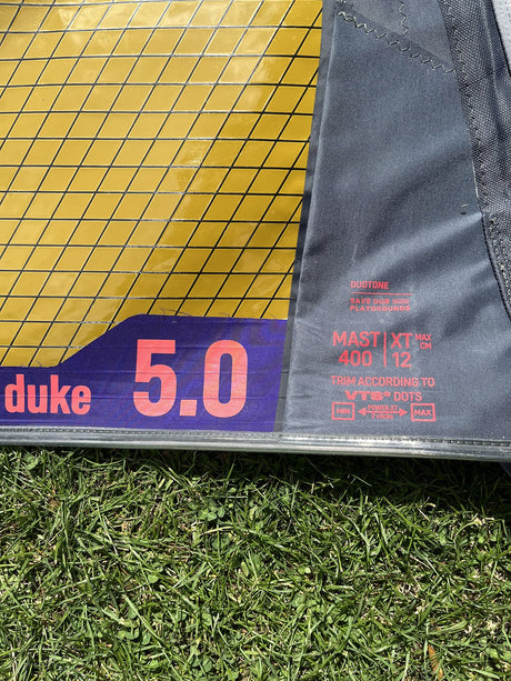 Duotone Duke 5 2026 Kitesegel gelb und grau, Detail der Segelkante mit Größenbezeichnung auf Gras