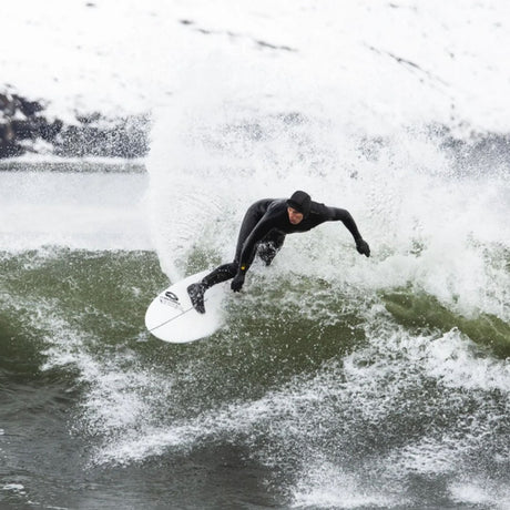 MDNS Neopren Haube Prime in Schwarz, Surfer auf Welle im Wasser tragend
