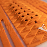 Roam Footpad Deck Grip Traction Comp Pad in Orange mit strukturierter Oberfläche und Grifflöchern, Detailansicht