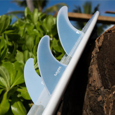 Futures Twiggy Step Up 5-Fin Set, weiße Surfflossen aus Kunststoff, angebracht auf weißem Surfboard, Detailaufnahme