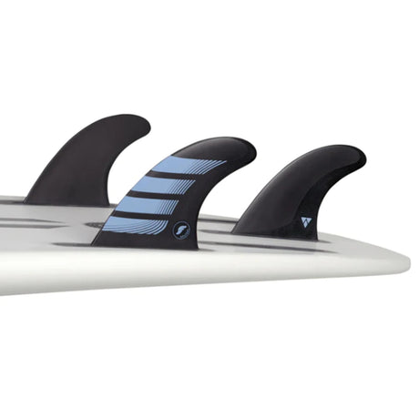 Futures Thruster Fin Set F2 Alpha, drei schwarze Flossen mit blauem Muster auf Surfboard montiert, Seitenansicht