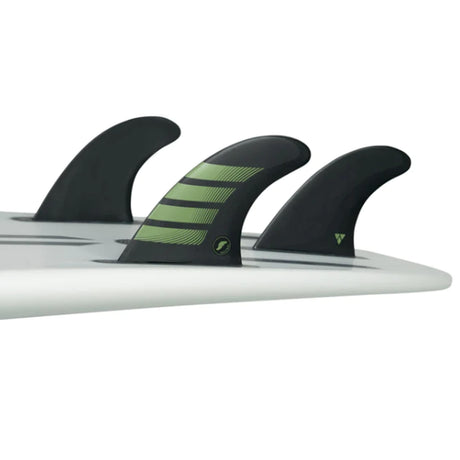 Futures Thruster Fin Set F8 Alpha, drei schwarze Flossen mit grünen Streifen auf Surfboard montiert