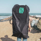 Sniper Bodyboard Rucksack Single Cover, schwarzer Stoff mit türkisem Logo, von vorne am Strand gezeigt