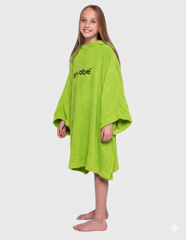 Dryrobe Kids Towel Robe Bio in Limone Grün, Frontansicht, Mädchen trägt die Kapuzenrobe mit weiten Ärmeln