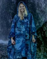 Dryrobe Regen-Poncho in Blau mit Camouflage-Muster, wasserdicht, Frau trägt Poncho im Regen