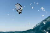 Duotone Sky Style SLS 2027 Kiteboard in Aktion über Wasser vor blauem Himmel, Untersicht