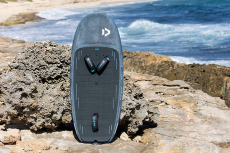 Duotone Sky Style SLS 2027 Kiteboard in Grau, Draufsicht auf Felsen am Strand mit Meereshintergrund
