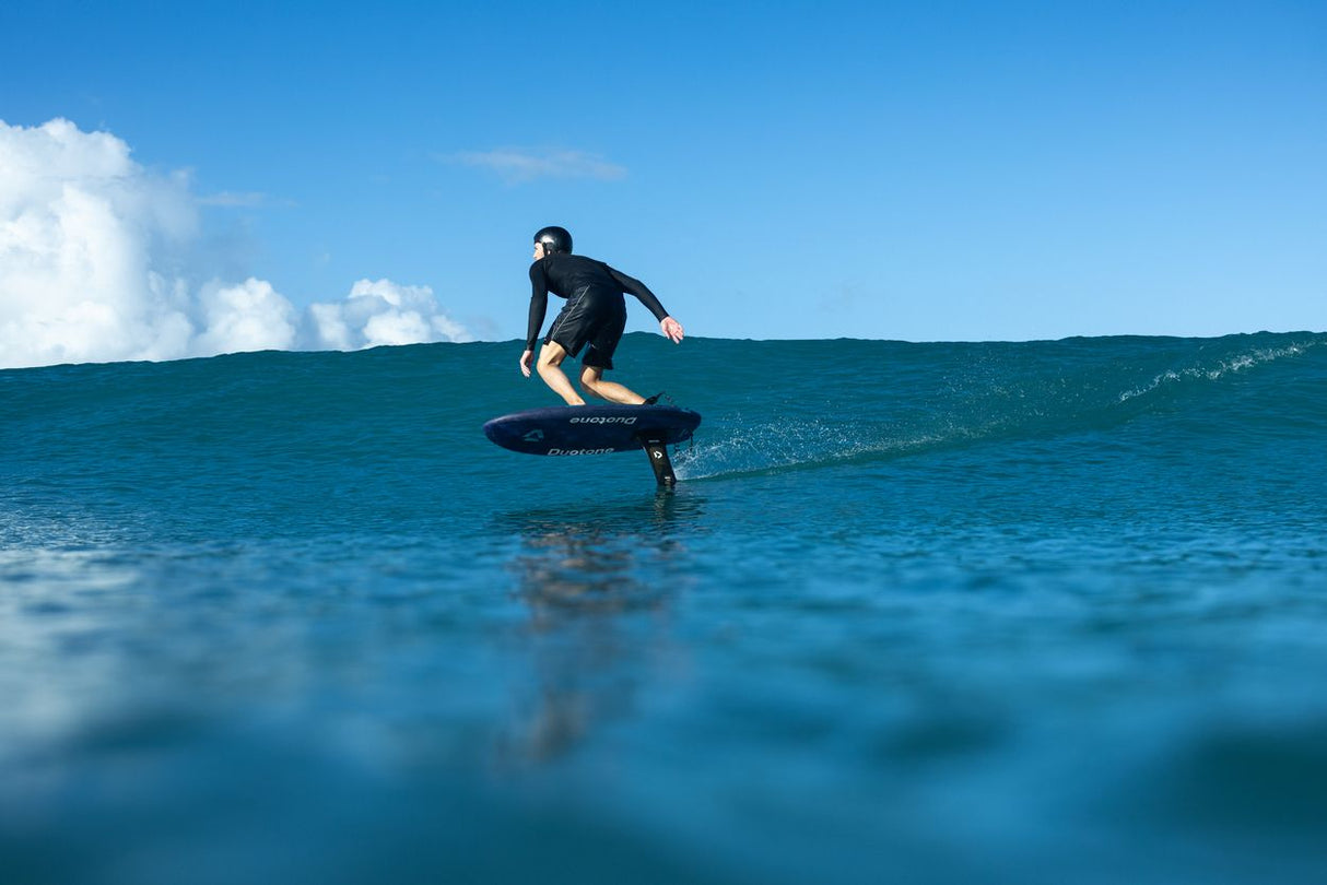 Duotone Crush SLS 2027 Kiteboard in Aktion auf dem Wasser, Fahrer auf Welle, Wassersportperspektive