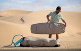 Duotone Boardbag Single Compact 2027 grau-blau, Mann trägt Kitebag in Wüstenlandschaft