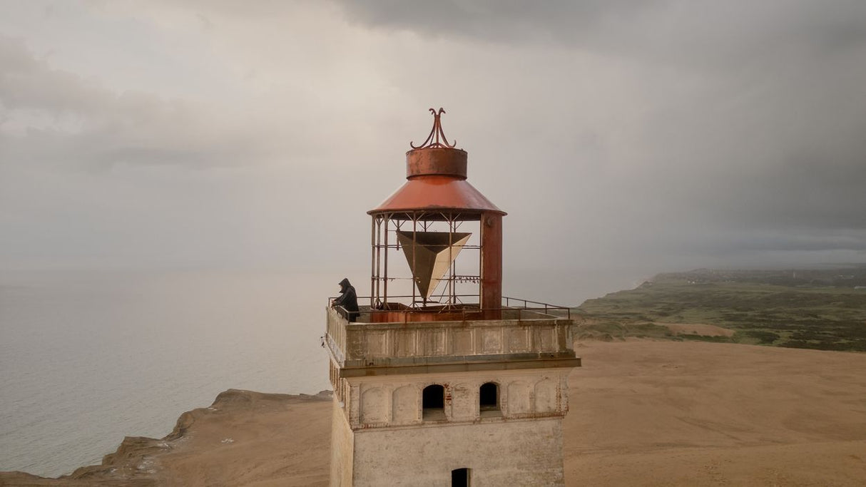 I appreciate your request, but I notice there's a mismatch between the instructions and the image provided. The image shows a lighthouse on a coastal cliff,...