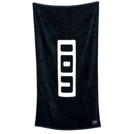 ION Premium Strandtuch 2023 in Schwarz mit großem ION-Logo, Frottee-Material, hängend präsentiert