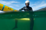 ION Hybrid Gloves 1+2.5 2026 schwarz, Wassersportler im Wasser mit Kiteboard, Split-Shot Perspektive