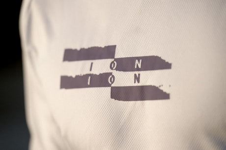 ION Wetshirt Kurzarm 2025 in Weiß mit dunkelgrauem ION Logo, Nahaufnahme des Brustdrucks
