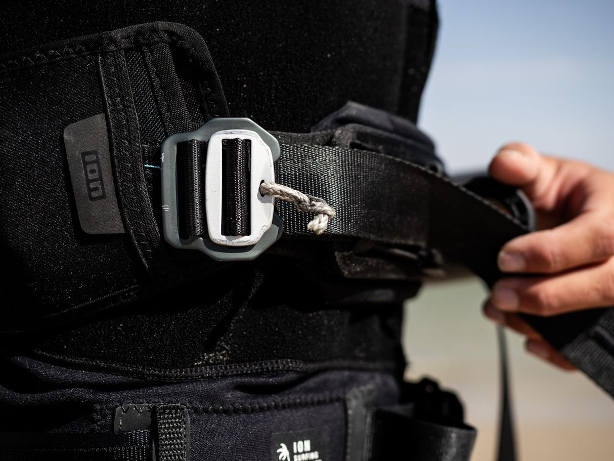 ION Rush Wing Vest 2026 schwarz, Neopren-Prallschutzweste mit Schnallenverschluss, Detailansicht der Befestigung