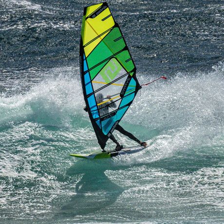 Patrik 5-Wave Windsurfegel in Gelb, Grün und Blau, in Action auf dem Wasser, Frontalansicht
