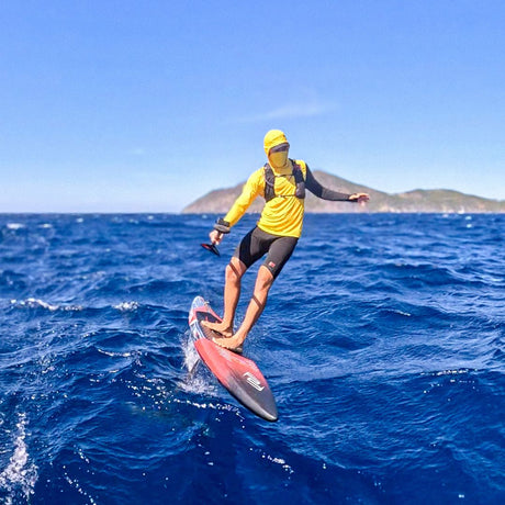 CHASE DW-R Downwind Racing Board, Athlet in gelbem Shirt auf rotem Board auf blauem Meer, Seitenansicht